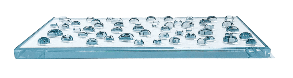 a glass plate after special coating with water that beads up instead of pools