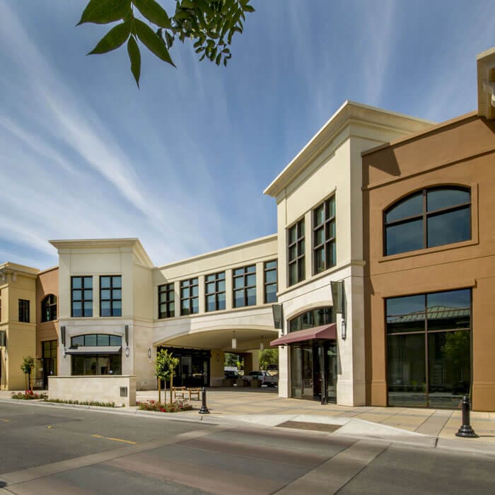 Two-story strip mall building with restaurants, retail, and office spaces